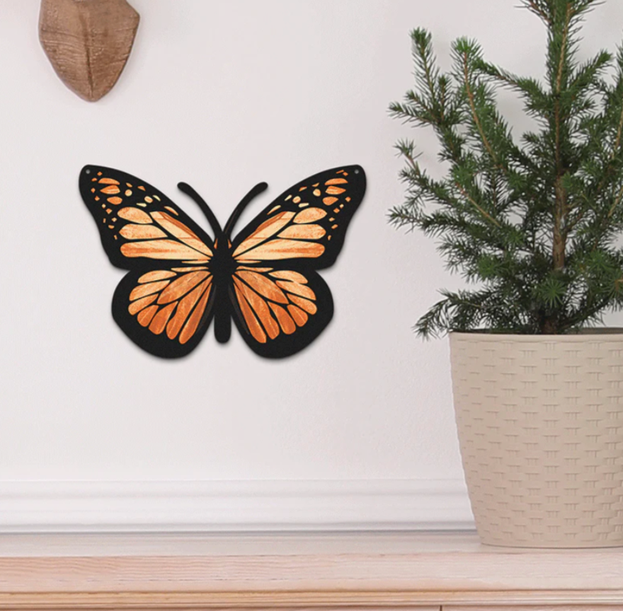 Metal butterfly sign hanging on a wall