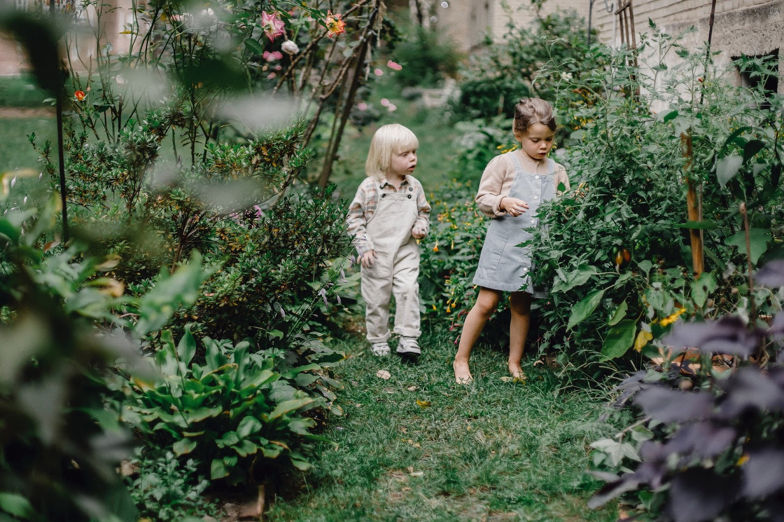 Two children playing in the garden.